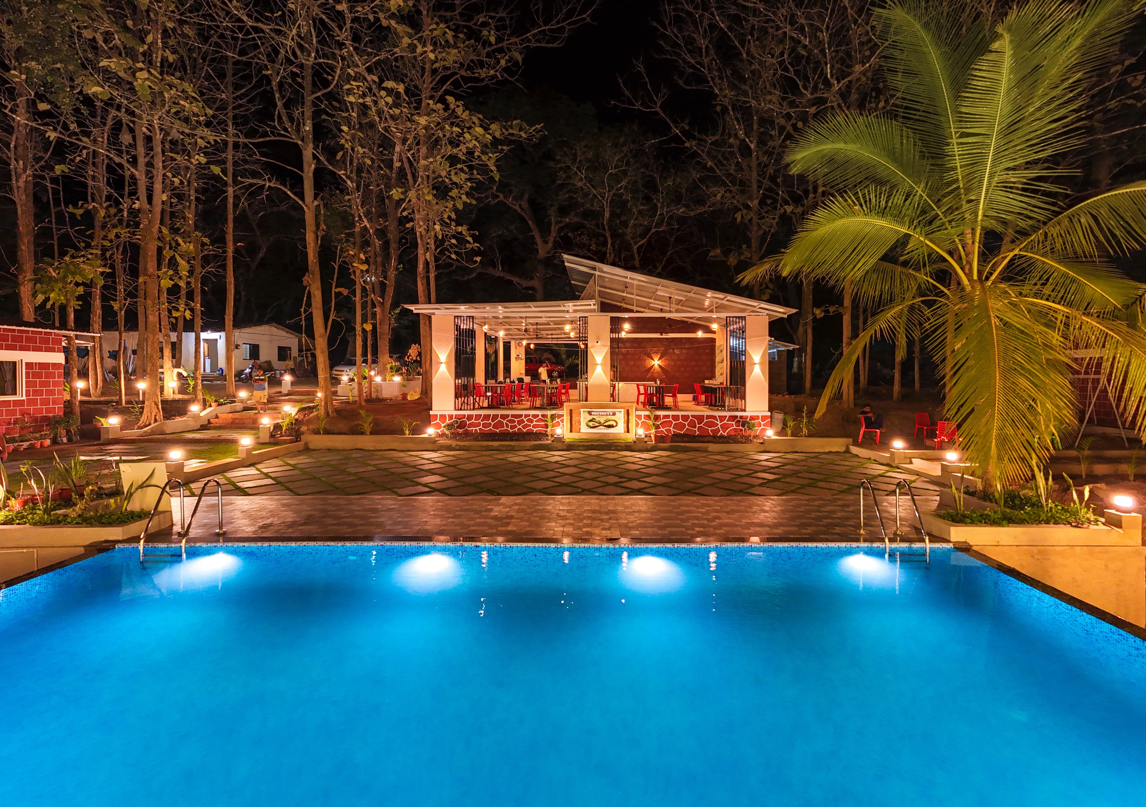 The beautifully lit swimming pool and hall area at night